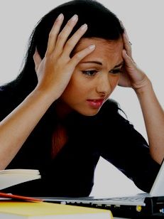 a young woman writing on a laptop computer