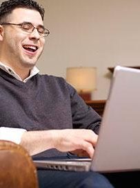 man-laughing-at-computer