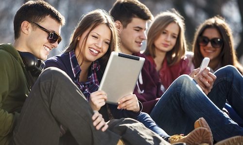 Young and happy urban people having fun with digital tablet